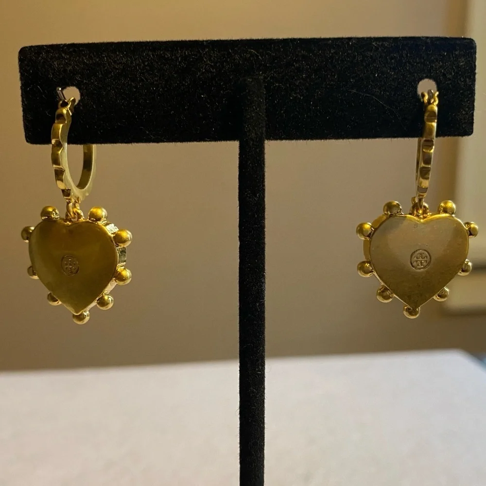 Tory Burch blue lapis heart drops hanging from huggie hoops.